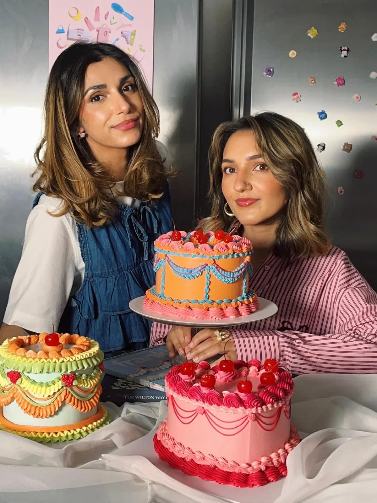 Roxy and Corinne presenting colourful buttercream cakes