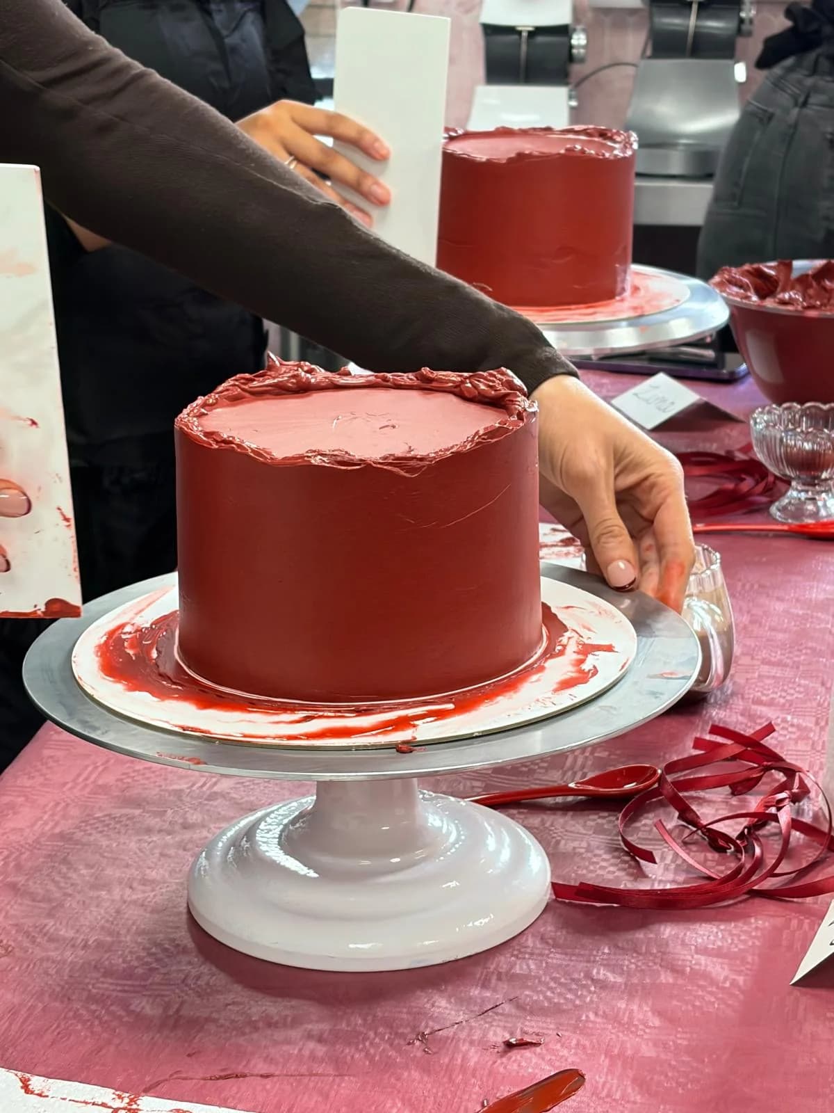 Students piping buttercream during a cake class