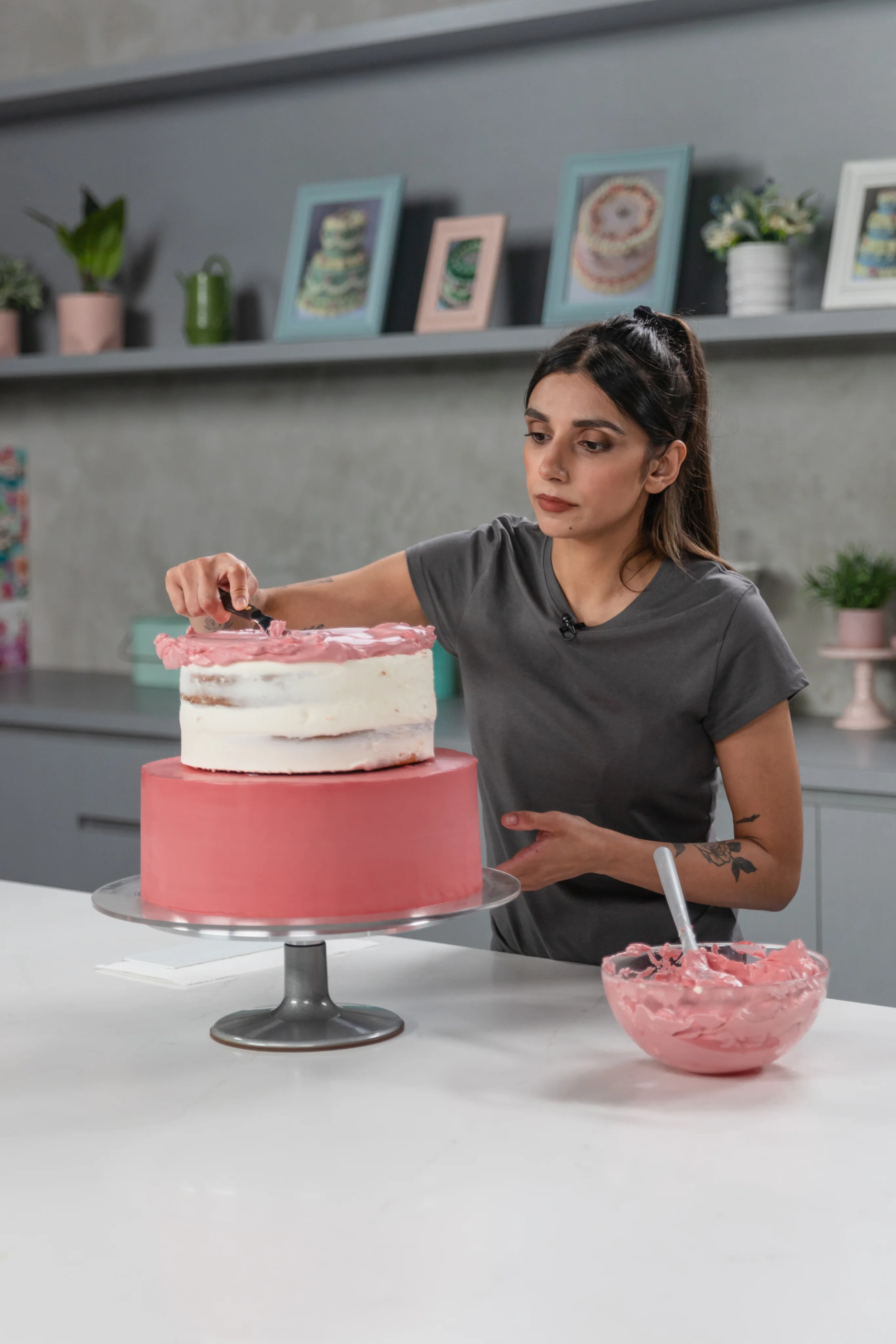 Baker guiding a student through cake decorating