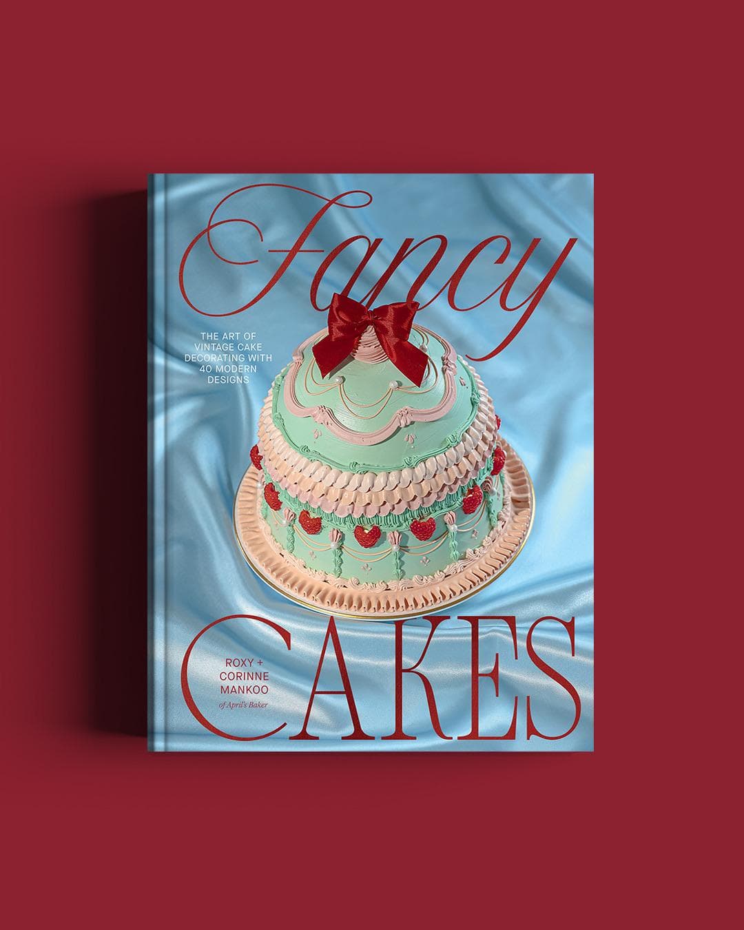 The Fancy Cakes book cover surrounded by piped cakes
