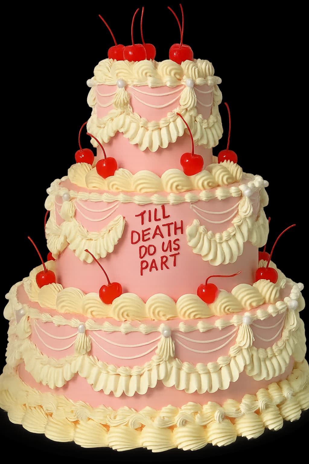 Three tier cream and pink cake piped with ‘Till death do us part’ and topped with cherries